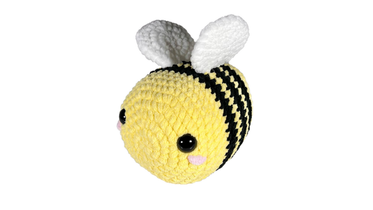 Huge yellow crochet bee with three black stripes and pink rosey cheeks.
