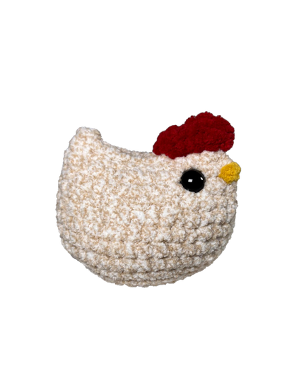 Speckled brown, and white crochet chicken.