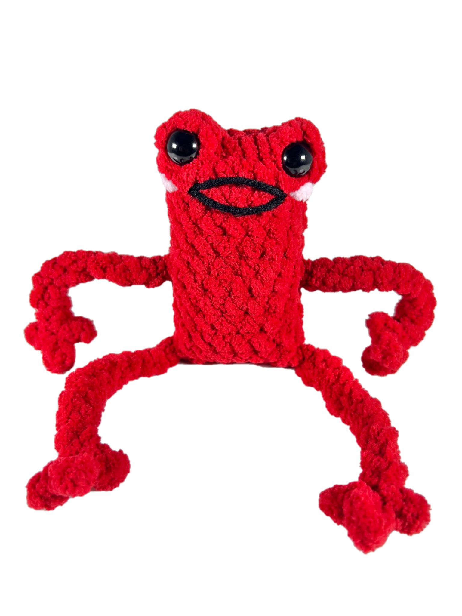 Red crochet frog plushie in excited pose smiling.