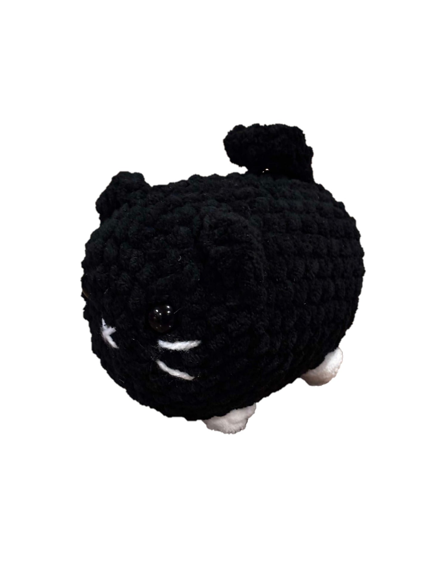 Black and white mixed color crochet loaf cat plushie.