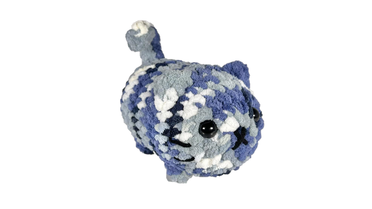 Blue and white mixed color crochet loaf cat plushie.