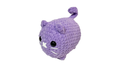 Purple colored crochet loaf cat plushie.