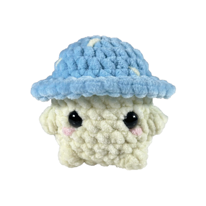 Blue crochet mushroom sitting looking forward.