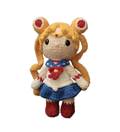 Crocheted plush toy of a character with blonde hair and red eyes on a white background