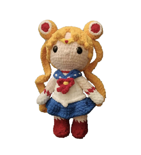Crocheted plush toy of a character with blonde hair and red eyes on a white background