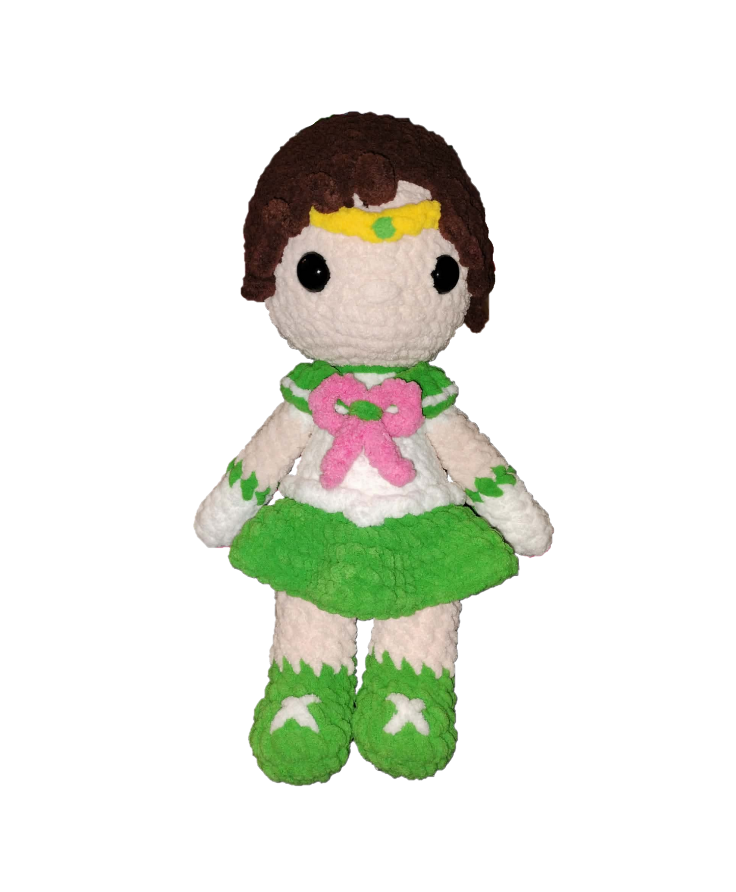 Plush toy figure of a character with brown hair, green outfit, and pink bow on a white background