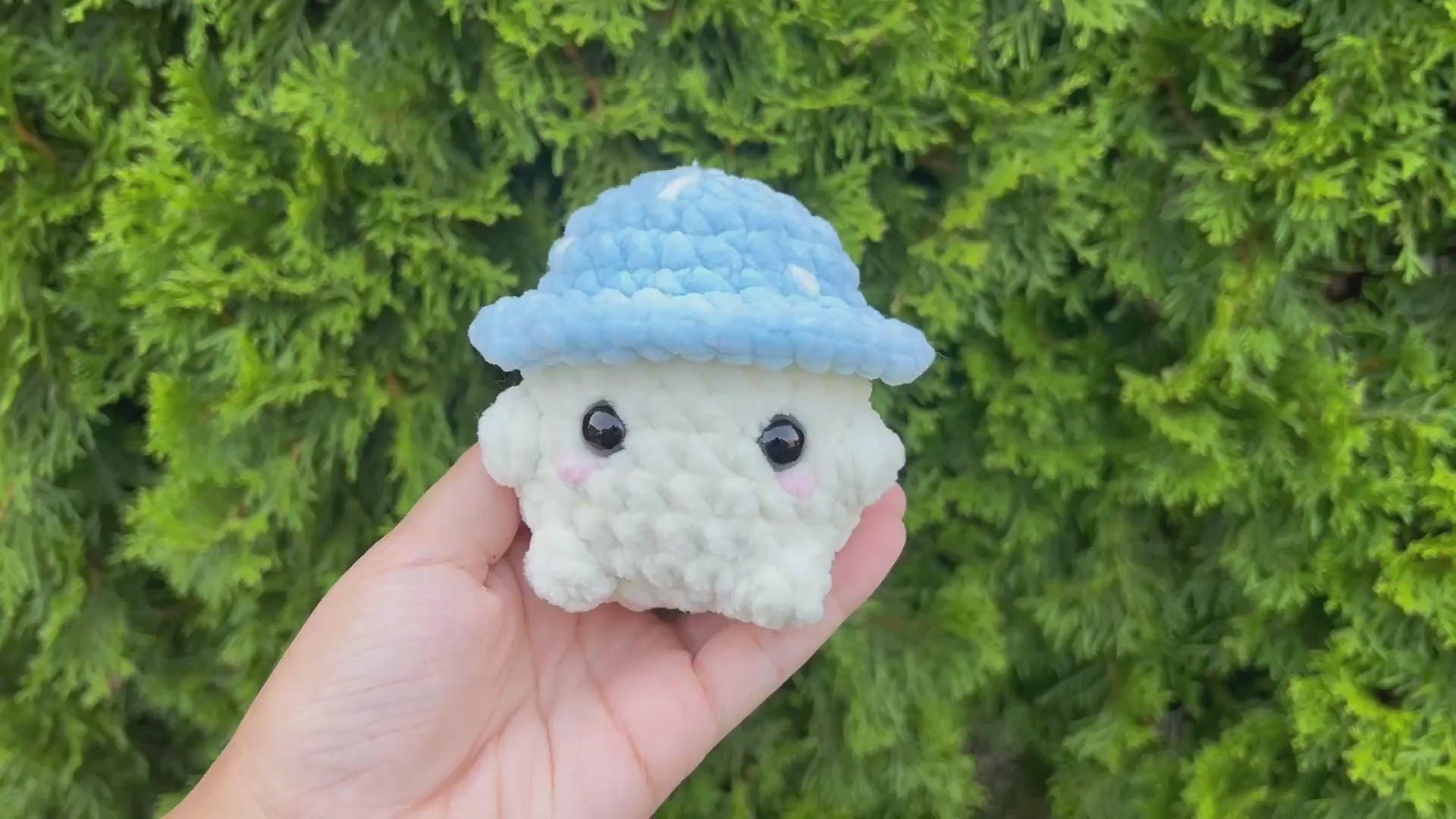 Video of blue crochet mushroom being held and turned to show all its sides.