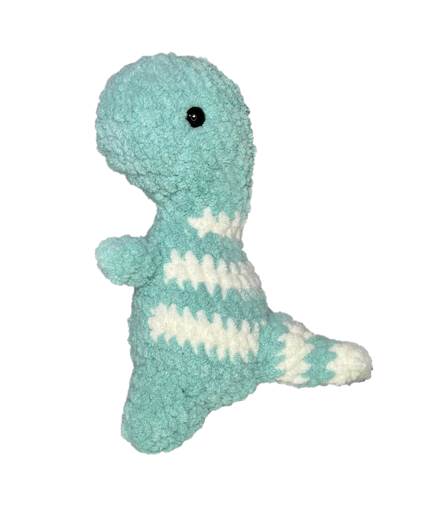 Green crochet dinosaur looking left.