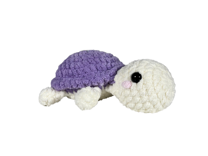 White turtle with purple shell blushing and facing right.