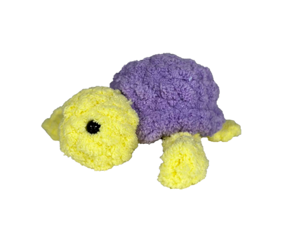 Yellow crochet turtle with a purple shell.